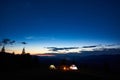 Family hikers having a rest at night camping in mountains Royalty Free Stock Photo