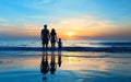 Silhouette of family hold hands on the beach at sunset,parents and children in water reflection