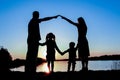 silhouette family, including his father, mother and two children in the hands of Royalty Free Stock Photo