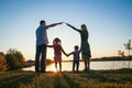 silhouette family, including his father, mother and two children in the hands of Royalty Free Stock Photo