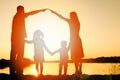 Silhouette family, including his father, mother and two children in the hands of Royalty Free Stock Photo