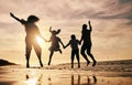 Silhouette, family jump on beach and sunset with ocean waves, back view and bonding in nature. Energy, people holding Royalty Free Stock Photo