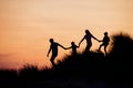 Silhouette of Family Running Through the Sand Dunes Royalty Free Stock Photo