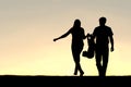 Silhouette of Family of Three People Walking at Sunset Royalty Free Stock Photo