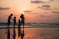 Silhouette family walking and playing at beach sunset with kids happy Royalty Free Stock Photo