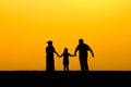 Silhouette of a family walking in sunset Royalty Free Stock Photo