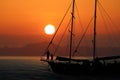 Silhouette family on the yacht with red sky sunset