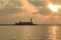 Silhouette of the Famous Haji Ali tomb on the Arabian seacoast against a sky pattern created by clouds and the setting sun