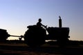 Silhouette of farmer on tractor