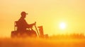 A Silhouette of Farmer on Tractor at Sunset Royalty Free Stock Photo