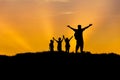 Silhouette father and children standing raised hands up on sunset Royalty Free Stock Photo
