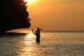 Silhouette Father and daughter enjoy swimming and snorkeling near the beach with sunset Royalty Free Stock Photo