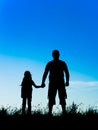 Silhouette father and daughter holding hands at sunset Royalty Free Stock Photo