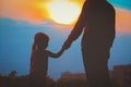 Silhouette of father and daughter holding hands at sunset Royalty Free Stock Photo