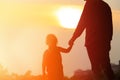 Silhouette of father and daughter holding hands at sunset Royalty Free Stock Photo