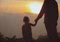 Silhouette of father and daughter holding hands at sunset Royalty Free Stock Photo