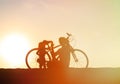 Silhouette of father and little daughter biking at sunset Royalty Free Stock Photo