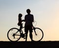 Silhouette of father and little daughter biking at sunset Royalty Free Stock Photo