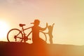 Silhouette of father and little daughter biking at sunset Royalty Free Stock Photo
