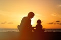 Silhouette of father and little daughter at sunset Royalty Free Stock Photo