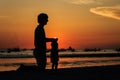 Silhouette of father and little daughter on sunset beach Royalty Free Stock Photo