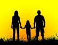 Silhouette father, mother and daughter holding hands at sunset