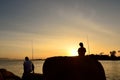 Silhouette of Father and son fishing in ocean Royalty Free Stock Photo