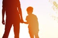 Silhouette of father and son holding hands at sunset Royalty Free Stock Photo