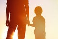 Silhouette of father and son holding hands at sunset Royalty Free Stock Photo