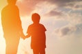 Silhouette of father and son holding hands at sunset Royalty Free Stock Photo
