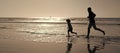 Silhouette of father and son run on summer beach outdoor, banner poster with copy space, dad and child silhouettes Royalty Free Stock Photo