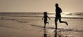 Silhouette of father and son run on summer beach outdoor, banner poster with copy space, father and son silhouettes Royalty Free Stock Photo