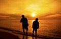 Silhouette of Father and son took a walk on the beach.