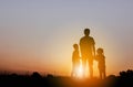 Silhouette of Father and two kids having fun on sunset, Happy family concept Royalty Free Stock Photo