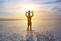 Silhouette father were riding neck carries daughter look out at the sea at sunset. Family enjoyed a holiday. Child stretch arm and Royalty Free Stock Photo