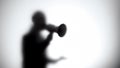 Silhouette of female activist talking in megaphone, discrimination protest