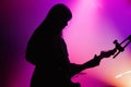 Silhouette of the female guitar player of Blood Red Shoes (band) performs