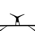 Silhouette of female gymnast on balance beam Royalty Free Stock Photo