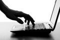 Silhouette of a female hands typing on the keyboard of the netbook Royalty Free Stock Photo