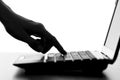 Silhouette of a female hands typing on the keyboard of the netbook Royalty Free Stock Photo