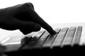Silhouette of a female hands typing on the keyboard of the netbook Royalty Free Stock Photo