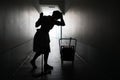 Silhouette of female maid with mop