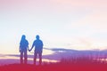 Silhouette of a female and male holding hands at sunset Royalty Free Stock Photo