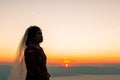 Silhouette of female during sunrise with morning sky background. Pre-wedding portraits happy images woman with sky nature