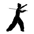 Silhouette of a female wushu martial art athlete in action with sword weapon.