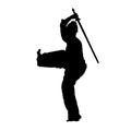 Silhouette of a female wushu martial art athlete in action with sword weapon.