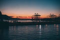 Silhouette of Ferris rides near the sea during sunset in Morocco Royalty Free Stock Photo