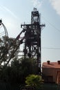 Silhouette of a ferris wheel and old mine head Royalty Free Stock Photo