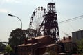 Silhouette of a ferris wheel and old mine head Royalty Free Stock Photo