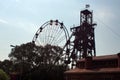 Silhouette of a ferris wheel and old mine head Royalty Free Stock Photo